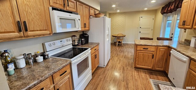 1608 W Briarwood Dr, Carbondale, IL 62901 - kitchen featuring white appliances, recessed lighting, light wood finished floors, brown cabinets, and a peninsula