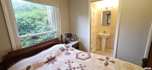 1608 W Briarwood Dr, Carbondale, IL 62901 - bedroom with multiple windows, ensuite bath, and a sink