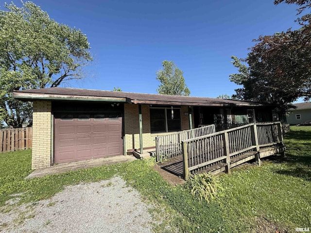 102 Stable Dr, Carterville, IL 62918 - ranch-style home with brick siding, an attached garage, driveway, a porch, and a front yard
