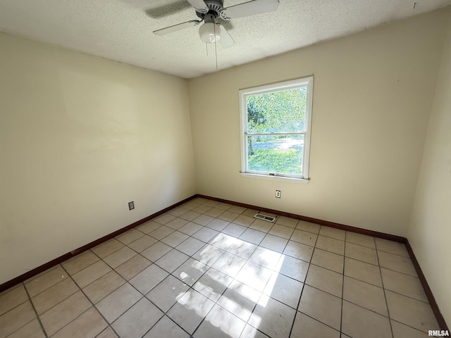 102 Stable Dr, Carterville, IL 62918 - empty room with ceiling fan, a textured ceiling, baseboards, and light tile patterned floors
