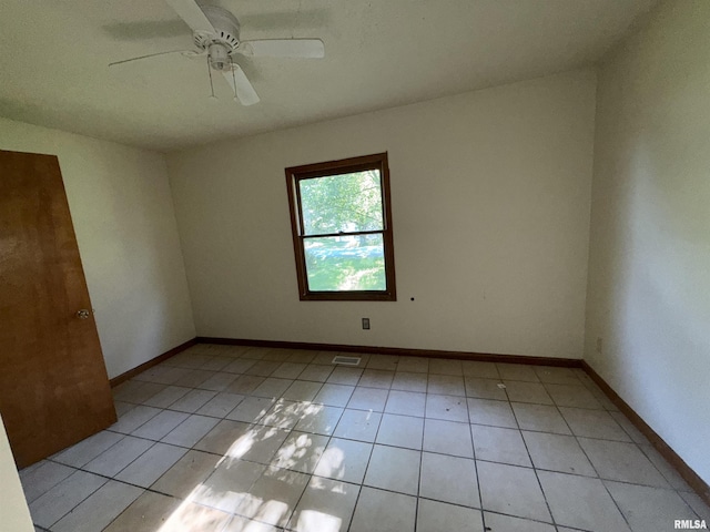 102 Stable Dr, Carterville, IL 62918 - spare room with light tile patterned floors, a ceiling fan, and baseboards