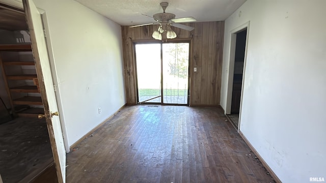 102 Stable Dr, Carterville, IL 62918 - unfurnished dining area featuring ceiling fan, wood finished floors, and wood walls
