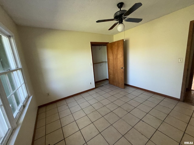 102 Stable Dr, Carterville, IL 62918 - unfurnished bedroom featuring baseboards, a closet, a ceiling fan, and light tile patterned flooring