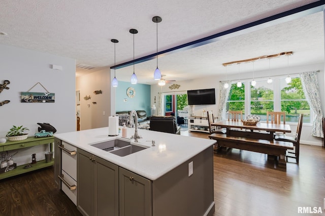 11782 Driftwood Dr, Marion, IL 62959 - kitchen featuring a sink, a textured ceiling, dark wood-type flooring, a ceiling fan, and hanging light fixtures