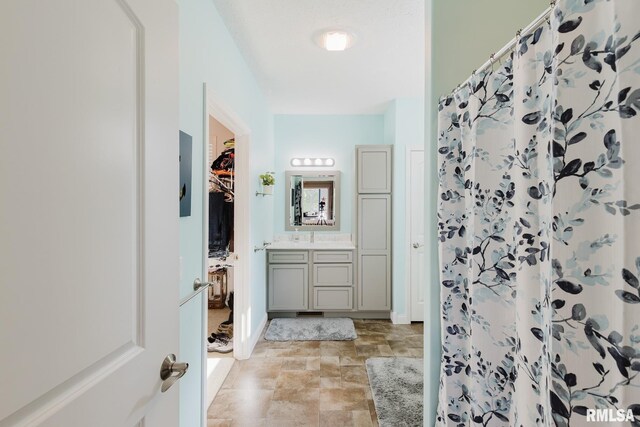 11782 Driftwood Dr, Marion, IL 62959 - bathroom featuring vanity, stone finish floors, a shower with shower curtain, and baseboards