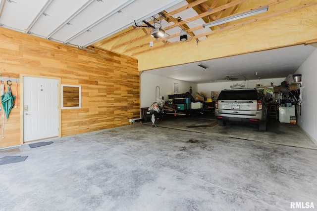 11782 Driftwood Dr, Marion, IL 62959 - garage with wood walls and a garage door opener