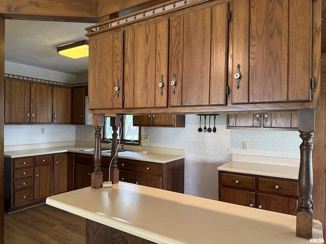19 Park Ln, Centralia, IL 62801 - kitchen with light countertops, dark wood-type flooring, wallpapered walls, and brown cabinetry