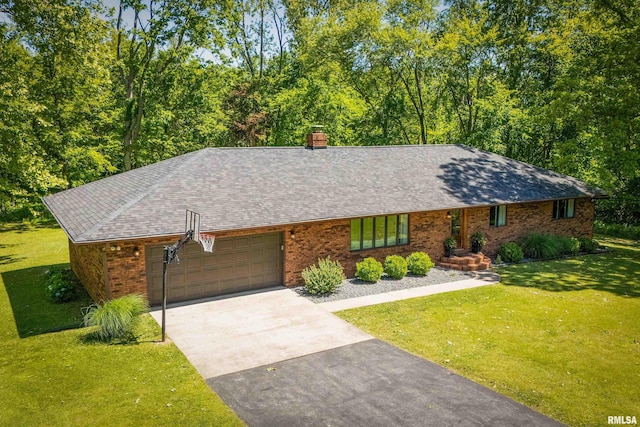 564 Cardinal Rd, Carbondale, IL 62901 - ranch-style home with a garage, brick siding, driveway, a front lawn, and roof with shingles