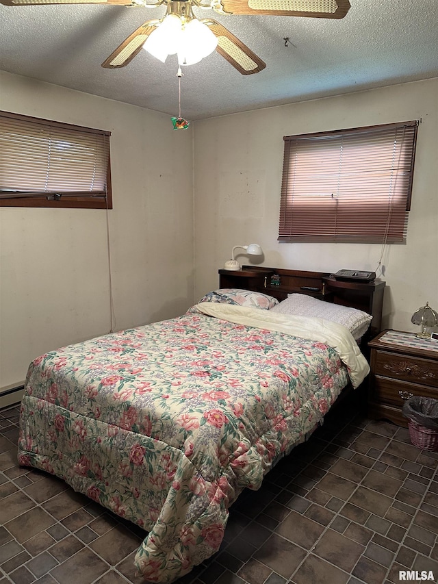 1480 Hemlock Rd, Duquoin, IL 62832 - bedroom featuring tile patterned flooring, ceiling fan, and a textured ceiling