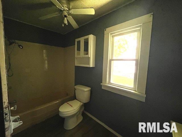 475 Holt St, Vergennes, IL 62994 - full bath with toilet, ceiling fan, wood finished floors, shower / tub combination, and baseboards