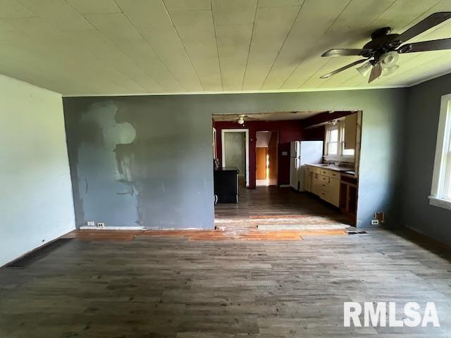 475 Holt St, Vergennes, IL 62994 - unfurnished living room featuring a ceiling fan, wood finished floors, plenty of natural light, and baseboards