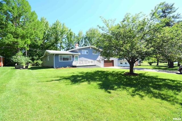 2704 Jamison Blvd, Mount Vernon, IL 62864 - view of front facade featuring concrete driveway, a front yard, a garage, and a chimney