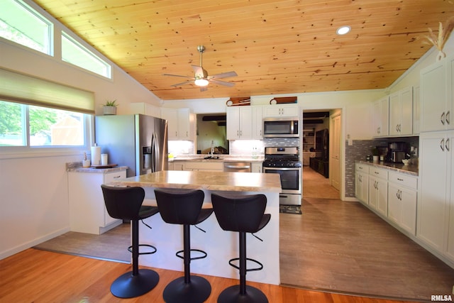 2704 Jamison Blvd, Mount Vernon, IL 62864 - kitchen with stainless steel appliances, lofted ceiling, wood ceiling, backsplash, and a kitchen island