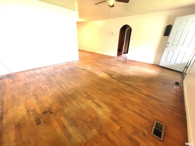 422 E Dr, Flora, IL 62839 - spare room featuring arched walkways, a ceiling fan, and light wood-type flooring