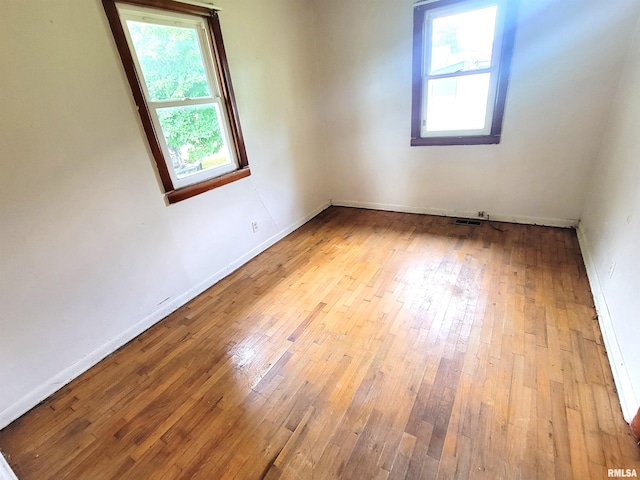 422 E Dr, Flora, IL 62839 - spare room featuring healthy amount of natural light, hardwood / wood-style flooring, and baseboards