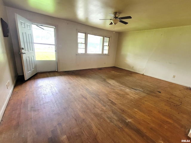422 E Dr, Flora, IL 62839 - empty room featuring dark wood-style flooring, baseboards, and ceiling fan