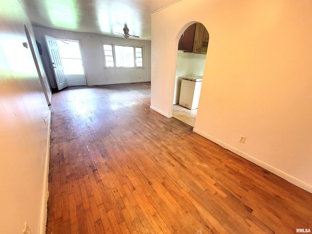 422 E Dr, Flora, IL 62839 - unfurnished room featuring arched walkways, hardwood / wood-style flooring, a ceiling fan, and baseboards