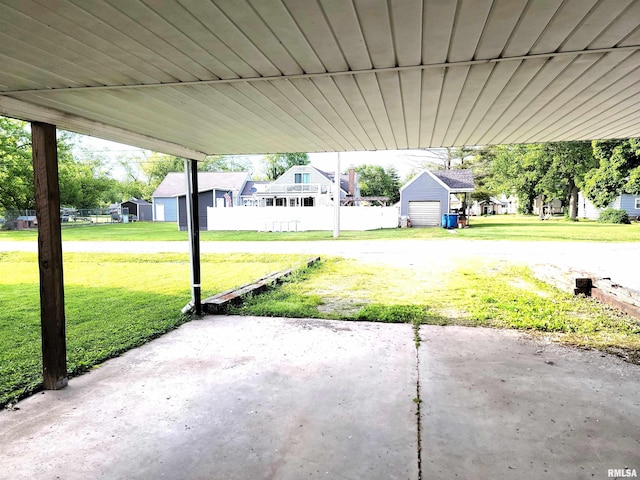 422 E Dr, Flora, IL 62839 - view of patio featuring a residential view, a garage, and an outdoor structure