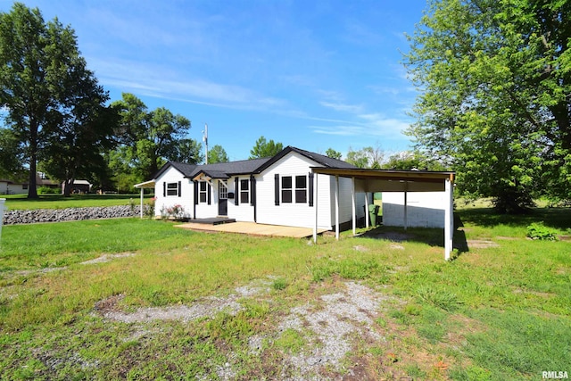 403 S Elm St, Ina, IL 62846 - back of property featuring a lawn and an attached carport