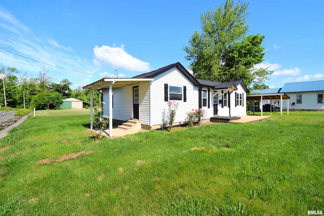 403 S Elm St, Ina, IL 62846 - back of house featuring a lawn and a carport