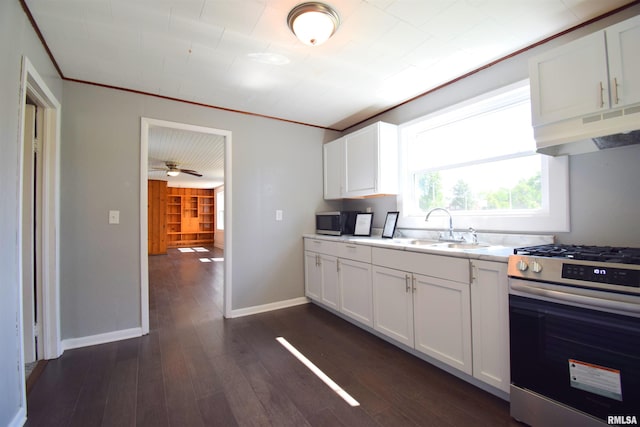 403 S Elm St, Ina, IL 62846 - kitchen featuring stainless steel range with gas stovetop, under cabinet range hood, light countertops, dark wood-style flooring, and white cabinets