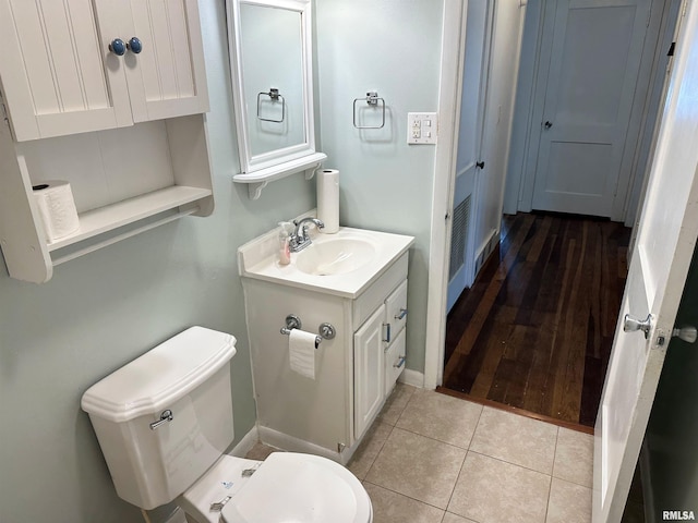 504 S James St, Carbondale, IL 62901 - bathroom with vanity, toilet, tile patterned flooring, and baseboards