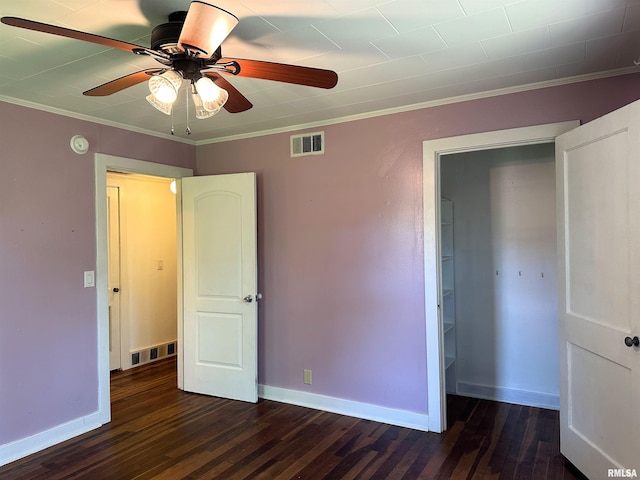 504 S James St, Carbondale, IL 62901 - unfurnished bedroom with dark wood-style flooring, baseboards, crown molding, and ceiling fan
