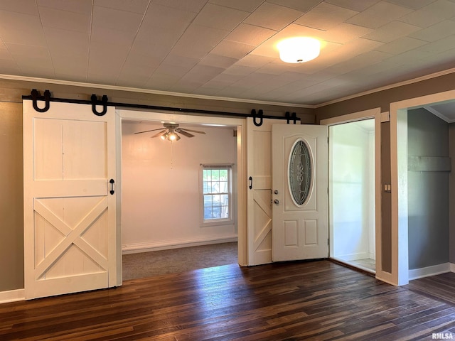 504 S James St, Carbondale, IL 62901 - entryway featuring a barn door, ornamental molding, dark wood-style floors, baseboards, and a ceiling fan