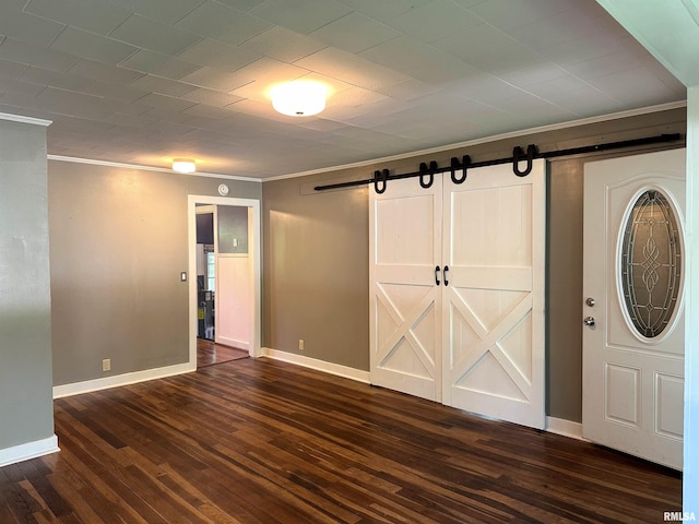 504 S James St, Carbondale, IL 62901 - foyer featuring a barn door, dark wood-type flooring, baseboards, and crown molding