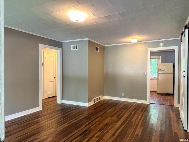 504 S James St, Carbondale, IL 62901 - empty room featuring ornamental molding, dark wood-style flooring, a barn door, and baseboards