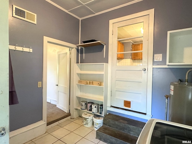 504 S James St, Carbondale, IL 62901 - entryway featuring water heater, tile patterned floors, and ornamental molding