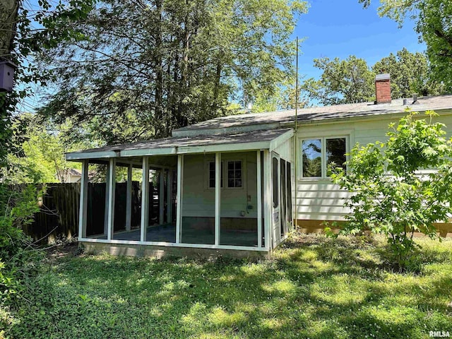 504 S James St, Carbondale, IL 62901 - back of property with a sunroom and a chimney