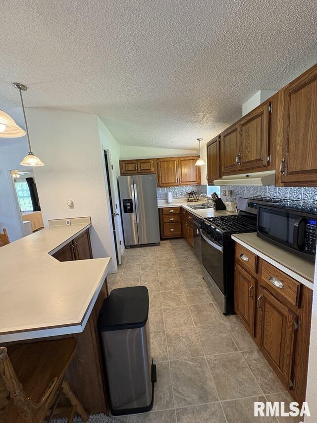 17227 Number 9 Blacktop Blacktop, West Frankfort, IL 62896 - kitchen featuring stainless steel appliances, light countertops, pendant lighting, brown cabinets, and a textured ceiling