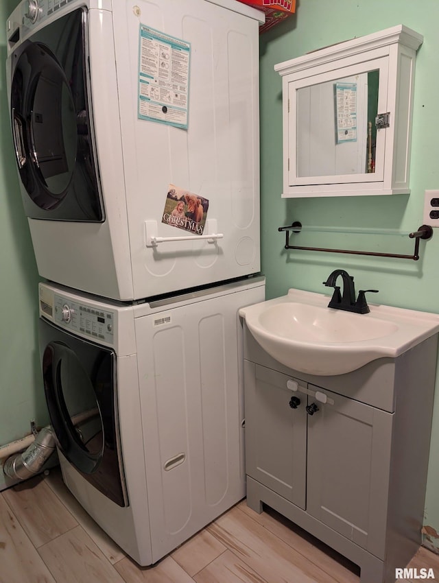 8271 Pigg Ln, Thompsonville, IL 62896 - laundry area featuring estacked washer and dryer and light wood finished floors