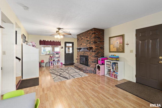 49 Jon St, Metropolis, IL 62960 - living area with wood finished floors, a fireplace, ceiling fan, and baseboards