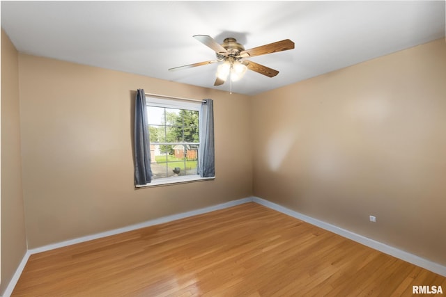 49 Jon St, Metropolis, IL 62960 - spare room featuring light wood-type flooring, baseboards, and ceiling fan