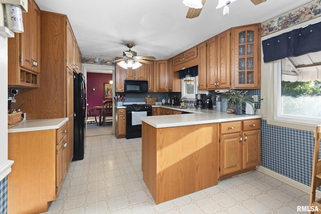 49 Jon St, Metropolis, IL 62960 - kitchen featuring black appliances, a ceiling fan, a peninsula, a sink, and light flooring