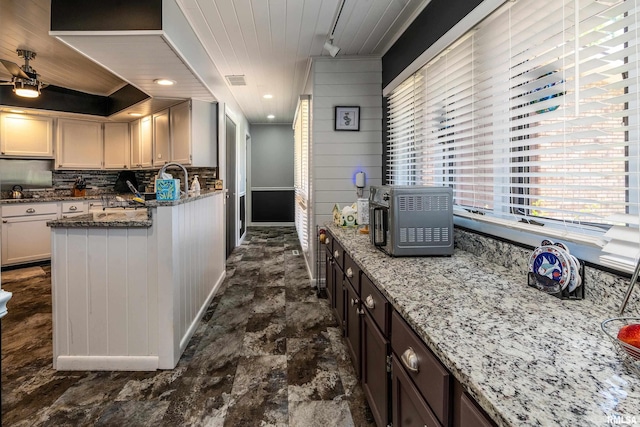 415 E Reichert Dr, Marion, IL 62959 - kitchen featuring decorative backsplash, light stone counters, a ceiling fan, wooden ceiling, and baseboards