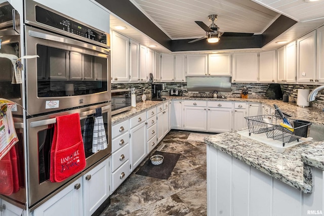 415 E Reichert Dr, Marion, IL 62959 - kitchen featuring stainless steel appliances, decorative backsplash, a sink, white cabinetry, and ceiling fan