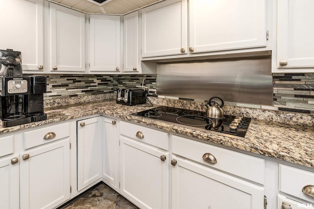 415 E Reichert Dr, Marion, IL 62959 - kitchen featuring white cabinets, decorative backsplash, black electric stovetop, light stone countertops, and dark stone finish floors