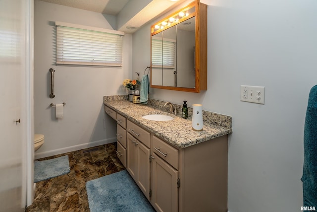 415 E Reichert Dr, Marion, IL 62959 - bathroom with vanity, baseboards, toilet, and stone finish floors