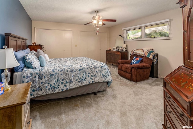 415 E Reichert Dr, Marion, IL 62959 - bedroom with light colored carpet, two closets, ceiling fan, and a textured ceiling