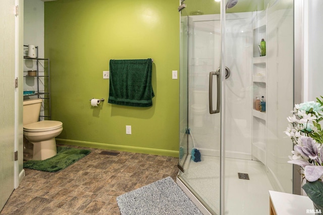 415 E Reichert Dr, Marion, IL 62959 - bathroom with toilet, a shower stall, and baseboards