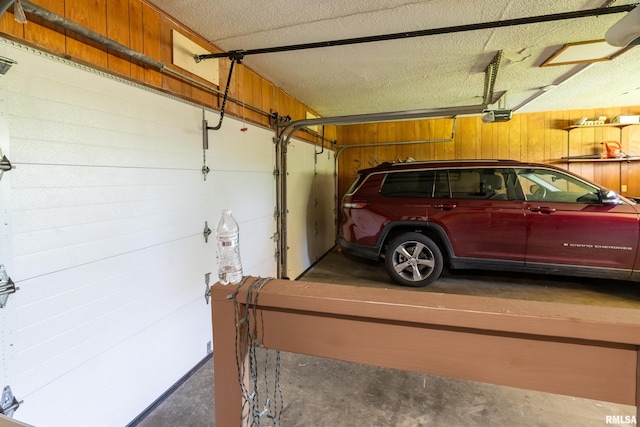 415 E Reichert Dr, Marion, IL 62959 - garage featuring a garage door opener and wood walls