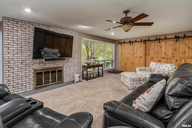 415 E Reichert Dr, Marion, IL 62959 - carpeted living room with ceiling fan, a textured ceiling, a barn door, and a fireplace