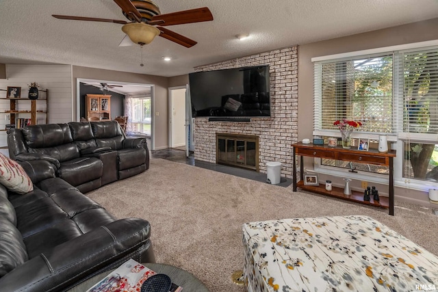 415 E Reichert Dr, Marion, IL 62959 - carpeted living room featuring a ceiling fan, a textured ceiling, and a fireplace