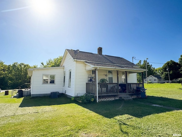 135 Walnut St, Alto Pass, IL 62905 - view of front of house with a porch, a front lawn, a chimney, and central AC unit