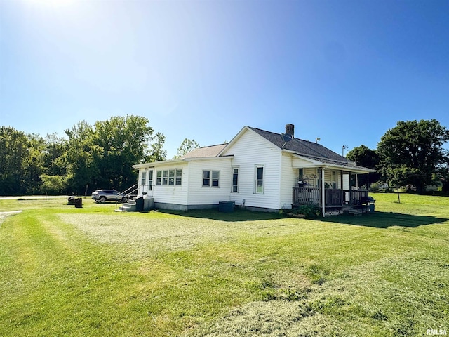135 Walnut St, Alto Pass, IL 62905 - view of property exterior featuring a yard, a chimney, central AC unit, and covered porch