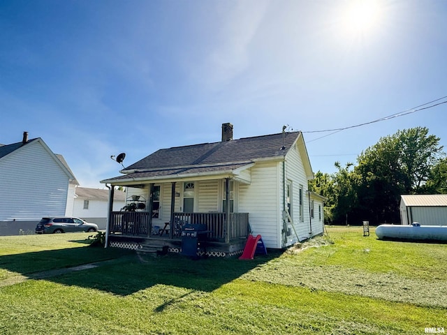 135 Walnut St, Alto Pass, IL 62905 - rear view of property featuring covered porch, a lawn, a chimney, and a shingled roof