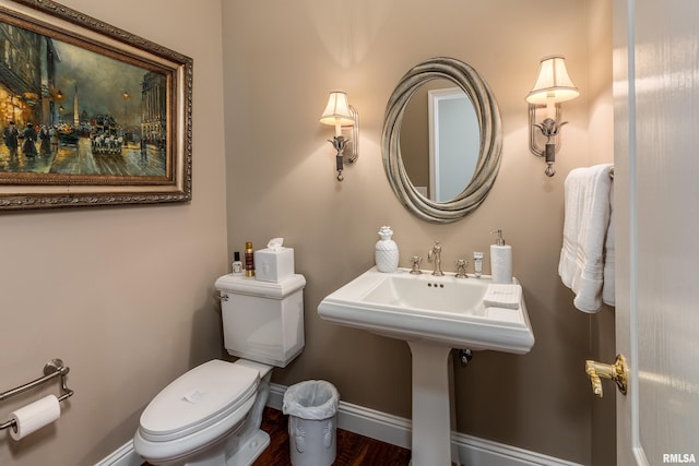 1302 Collins Ln, Marion, IL 62959 - bathroom with toilet, baseboards, and wood finished floors